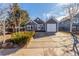 Charming blue home with a well-manicured lawn and a single-car attached garage at 17665 E Temple Dr, Aurora, CO 80015