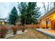 Large backyard showing the lawn area, rock feature and the outdoor patio space at 7743 S Jersey Way, Centennial, CO 80112