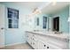 Bathroom with double sinks, granite counters, and tile floors at 7743 S Jersey Way, Centennial, CO 80112