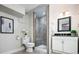 Basement bathroom features a tiled shower stall, toilet and vanity at 7743 S Jersey Way, Centennial, CO 80112