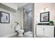 Charming bathroom featuring a walk-in shower with tiled walls, a modern vanity, and neutral decor at 7743 S Jersey Way, Centennial, CO 80112