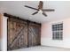 Bedroom featuring barn doors and carpet at 7743 S Jersey Way, Centennial, CO 80112