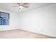 Bright bedroom featuring a ceiling fan, window, and neutral carpeting at 7743 S Jersey Way, Centennial, CO 80112