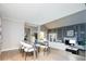 Elegant dining area flowing into the living room with fireplace and modern furnishings at 7743 S Jersey Way, Centennial, CO 80112