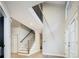 Open entryway featuring a staircase with iron railing, natural light, and a welcoming foyer at 7743 S Jersey Way, Centennial, CO 80112