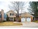 Inviting two-story home featuring a two-car garage, classic design, and well-manicured lawn at 7743 S Jersey Way, Centennial, CO 80112