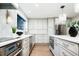 Bright kitchen with stainless steel appliances, modern cabinetry, and a view of the backyard at 7743 S Jersey Way, Centennial, CO 80112