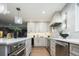 Well-lit kitchen featuring stainless steel appliances, white cabinets, and hardwood floors at 7743 S Jersey Way, Centennial, CO 80112