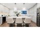 Contemporary kitchen with a large island, pendant lighting, and stainless steel appliances at 7743 S Jersey Way, Centennial, CO 80112