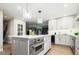 Open kitchen with an island, modern appliances, and seamless flow to the dining area at 7743 S Jersey Way, Centennial, CO 80112