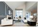 Cozy living room with a fireplace, comfortable seating, and large windows for natural light at 7743 S Jersey Way, Centennial, CO 80112