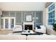 Comfortable living room featuring a fireplace, French doors, and elegant design at 7743 S Jersey Way, Centennial, CO 80112