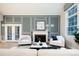 Comfortable living room featuring a fireplace and access to a wet bar adjacent to kitchen at 7743 S Jersey Way, Centennial, CO 80112