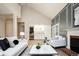 Open-concept living space with modern furniture, fireplace, and seamless flow into the dining area at 7743 S Jersey Way, Centennial, CO 80112