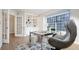 Well-lit office with large window, built-in shelving and a comfortable chair at 7743 S Jersey Way, Centennial, CO 80112