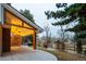 Expansive covered outdoor patio with a stone fireplace overlooking the yard and wooden fence at 7743 S Jersey Way, Centennial, CO 80112