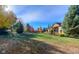 Spacious backyard with large lawn and colorful trees at 449 Meadow View Pkwy, Erie, CO 80516