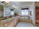 Elegant bathroom featuring a soaking tub, double vanity, and a walk-in shower at 449 Meadow View Pkwy, Erie, CO 80516