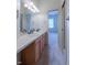 Double vanity bathroom with a view into a bedroom at 449 Meadow View Pkwy, Erie, CO 80516