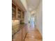Bright hallway with hardwood floors and built-in cabinetry at 449 Meadow View Pkwy, Erie, CO 80516