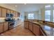 Modern kitchen with granite countertops, stainless steel appliances, and hardwood floors at 449 Meadow View Pkwy, Erie, CO 80516
