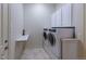 Convenient laundry room with washer, dryer, and extra storage at 449 Meadow View Pkwy, Erie, CO 80516