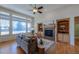 Open living space with hardwood floors, fireplace, and built-in shelves at 449 Meadow View Pkwy, Erie, CO 80516