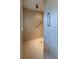 Walk-in shower with grab bars and tiled walls at 449 Meadow View Pkwy, Erie, CO 80516
