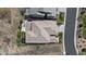 An aerial view shows the home with its tile roof, backyard patio, landscaping, and proximity to the street at 507 Red Thistle Dr, Highlands Ranch, CO 80126
