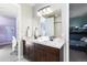 Spacious bathroom boasts double sinks, sleek countertops, and a vanity with dark wood cabinets at 507 Red Thistle Dr, Highlands Ranch, CO 80126