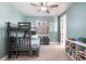 Charming bedroom with blue walls, bunk beds, and built-in shelving for optimal storage and display at 507 Red Thistle Dr, Highlands Ranch, CO 80126