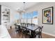 Elegant dining room with modern chandelier, long wooden table, seating for eight, and a built-in display cabinet at 507 Red Thistle Dr, Highlands Ranch, CO 80126