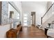 Bright, welcoming foyer with hardwood floors, modern console table, and a staircase, flooded with natural light at 507 Red Thistle Dr, Highlands Ranch, CO 80126