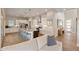 Open kitchen with white cabinets, stainless steel appliances, large island with seating, and hardwood floors at 507 Red Thistle Dr, Highlands Ranch, CO 80126