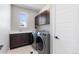 Functional laundry room featuring modern washer and dryer, ample cabinetry, and a convenient utility sink at 507 Red Thistle Dr, Highlands Ranch, CO 80126