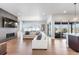 Spacious living room with hardwood floors, fireplace, built-in shelving, and sliding glass doors to the patio at 507 Red Thistle Dr, Highlands Ranch, CO 80126
