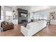 Cozy living room featuring a modern fireplace, built-in shelves, hardwood floors, and ample seating at 507 Red Thistle Dr, Highlands Ranch, CO 80126