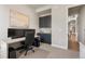 Home office featuring built-in cabinets, a modern desk, and neutral decor at 507 Red Thistle Dr, Highlands Ranch, CO 80126