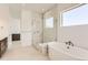 Modern bathroom with dual sinks, stone countertops, a walk-in shower, and a soaking tub at 483 Agoseris Way, Castle Rock, CO 80104