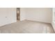 Bright bedroom featuring neutral carpet, white walls, baseboards and a glimpse into the primary bath at 483 Agoseris Way, Castle Rock, CO 80104