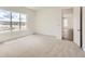 A spacious bedroom featuring neutral carpet, white walls and large windows offering bright light at 483 Agoseris Way, Castle Rock, CO 80104