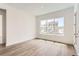 Sun-filled bedroom with a large window and hardwood floors at 483 Agoseris Way, Castle Rock, CO 80104