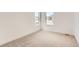 Bright bedroom with carpet, baseboards, white walls, and a window letting in natural light at 483 Agoseris Way, Castle Rock, CO 80104