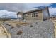 Exterior shot of a home with tan siding and gravel landscaping at 483 Agoseris Way, Castle Rock, CO 80104