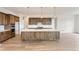 Bright kitchen featuring wood cabinets, stainless steel appliances, and a large center island with a white countertop at 483 Agoseris Way, Castle Rock, CO 80104