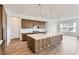 Bright kitchen showcasing stainless steel appliances, recessed lights, wood cabinets, and a white countertop island at 483 Agoseris Way, Castle Rock, CO 80104
