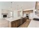 Modern kitchen with a center island with white countertop, stainless steel appliances and an adjoining living area at 483 Agoseris Way, Castle Rock, CO 80104