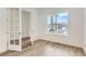 Bright living area featuring light wood floors, white walls, large windows and modern french doors at 483 Agoseris Way, Castle Rock, CO 80104