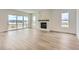 Bright living room featuring a marble fireplace, modern sliding glass doors and wood floors at 483 Agoseris Way, Castle Rock, CO 80104