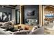 Beautiful living room features modern fireplace, neutral colors, and comfortable seating for relaxing at 483 Agoseris Way, Castle Rock, CO 80104